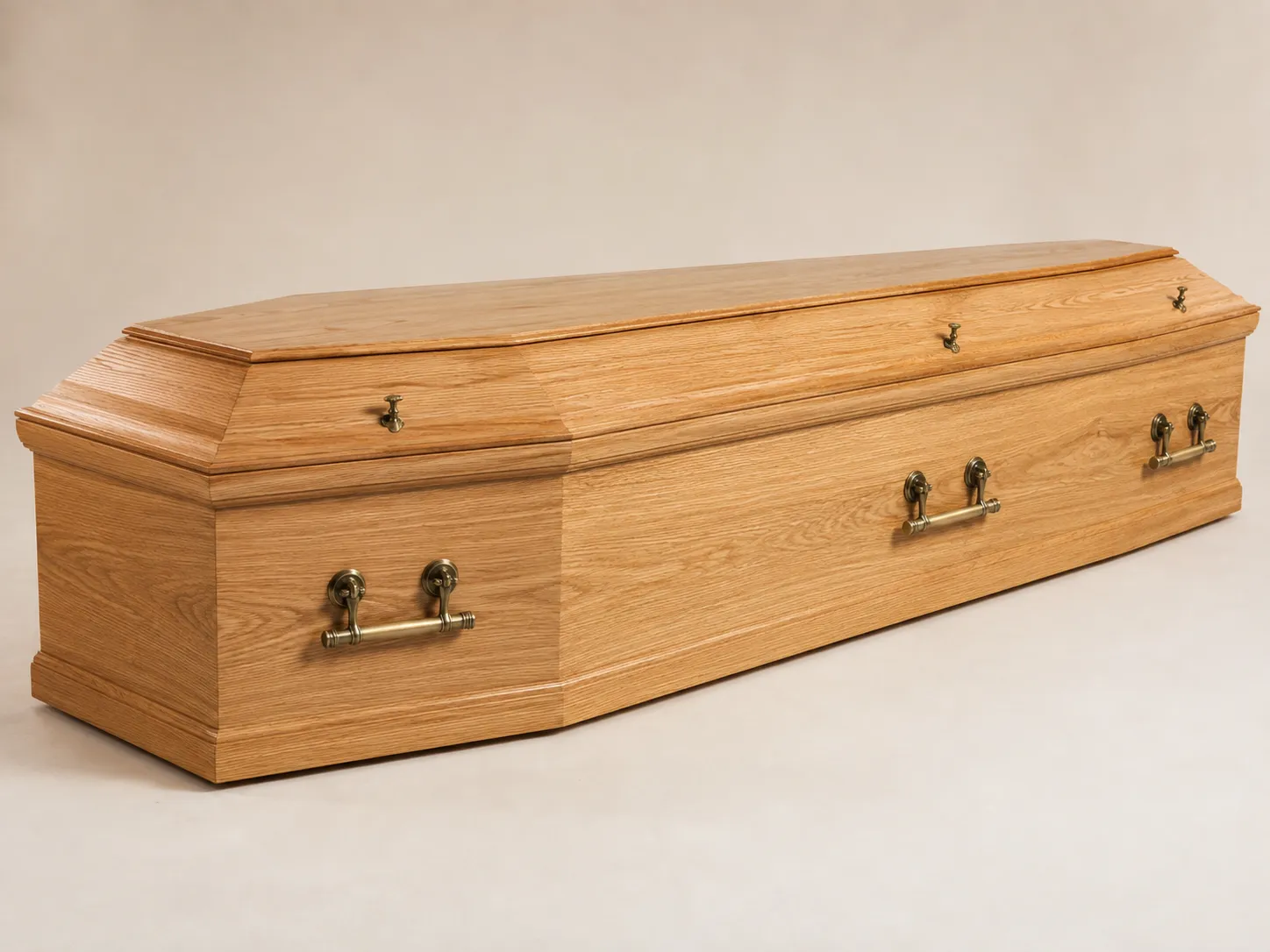 Light oak-finish casket with brass handles